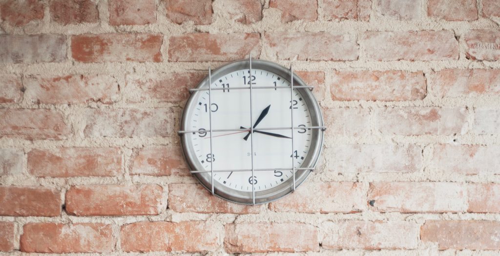clock on a brick wall